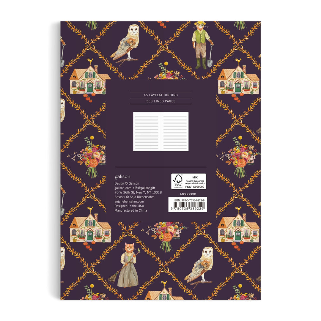 The Cottage Cats A5 Premium Notebook by Anja Riebensahm features a purple back cover adorned with houses, flower bouquets, an owl, vintage-dressed characters, and orange floral garlands.
