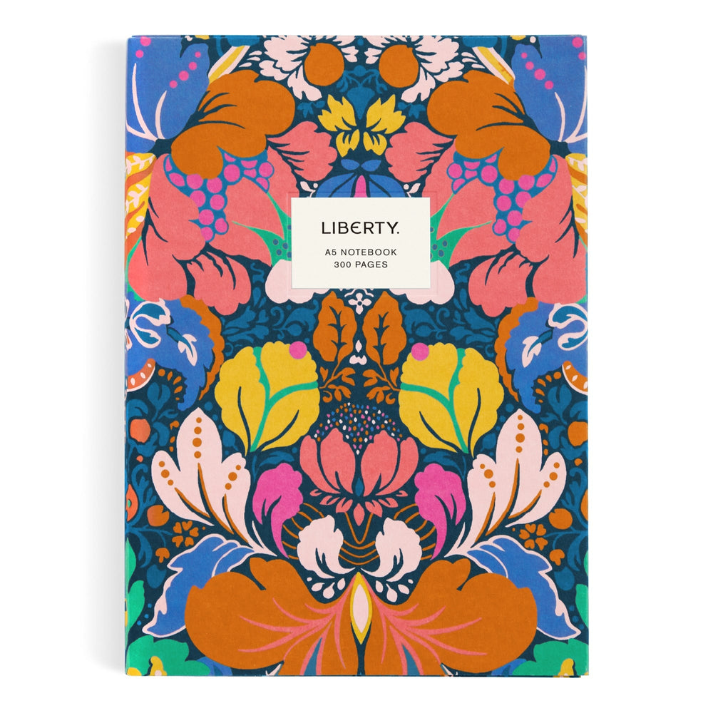 The Liberty London Glastonbury Premium A5 Notebook features a vibrant, symmetrical floral pattern in orange, pink, yellow, blue, and green with a central white label reading: LIBERTY. A5 NOTEBOOK 300 PAGES.