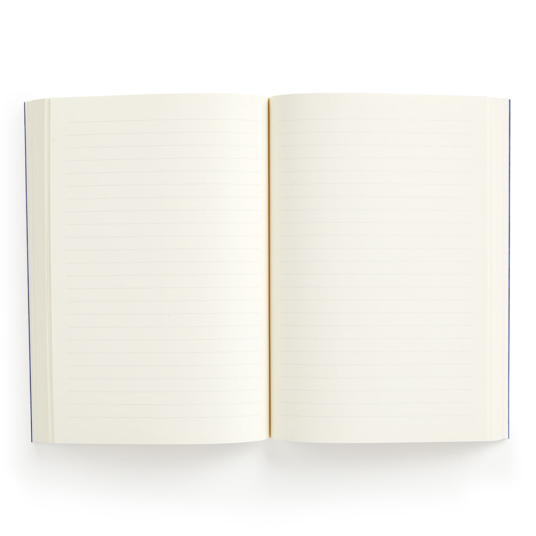 The Liberty Glastonbury Premium A5 Notebook by Liberty London is shown open from above, displaying both blank, lined pages with premium white or light cream paper thats ready for writing.