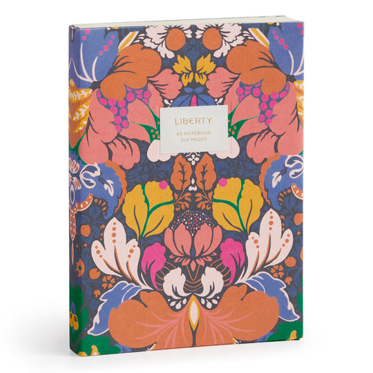 The Liberty Glastonbury Premium A5 Notebook by Liberty London has 300 pages of premium paper and a vibrant floral and abstract cover in orange, pink, yellow, blue, and green. The front label reads: LIBERTY A5 NOTEBOOK 300 PAGES.