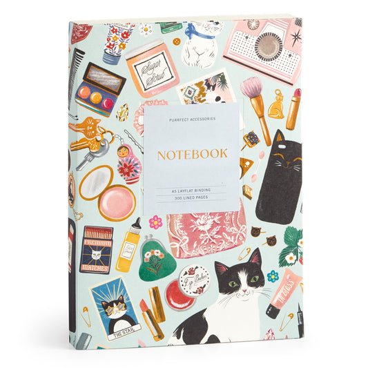 The Purrfect Accessories Premium A5 Notebook by Christine De Carvalho features colorful cats, makeup, perfume, and cute accessories on the cover—a chic stationery item labeled Notebook and Perfect Accessories for your desk.