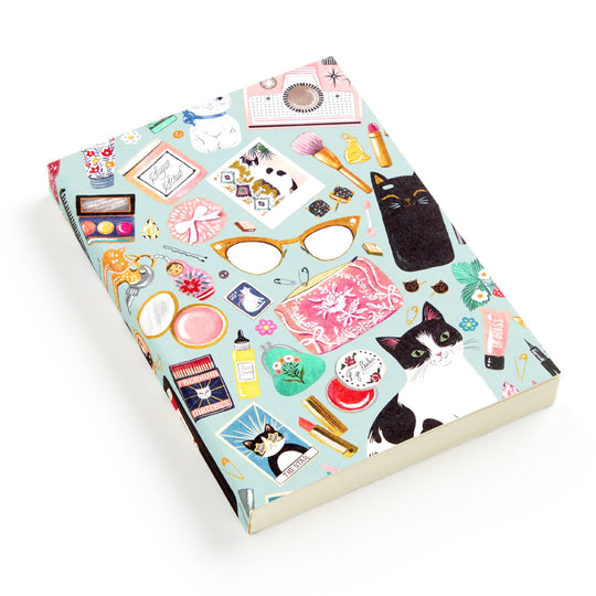 The Christine De Carvalho Purrfect Accessories Premium A5 Notebook features a vibrant cover with cats, glasses, makeup, flowers, perfume, and more—a delightful choice for cat stationery enthusiasts.