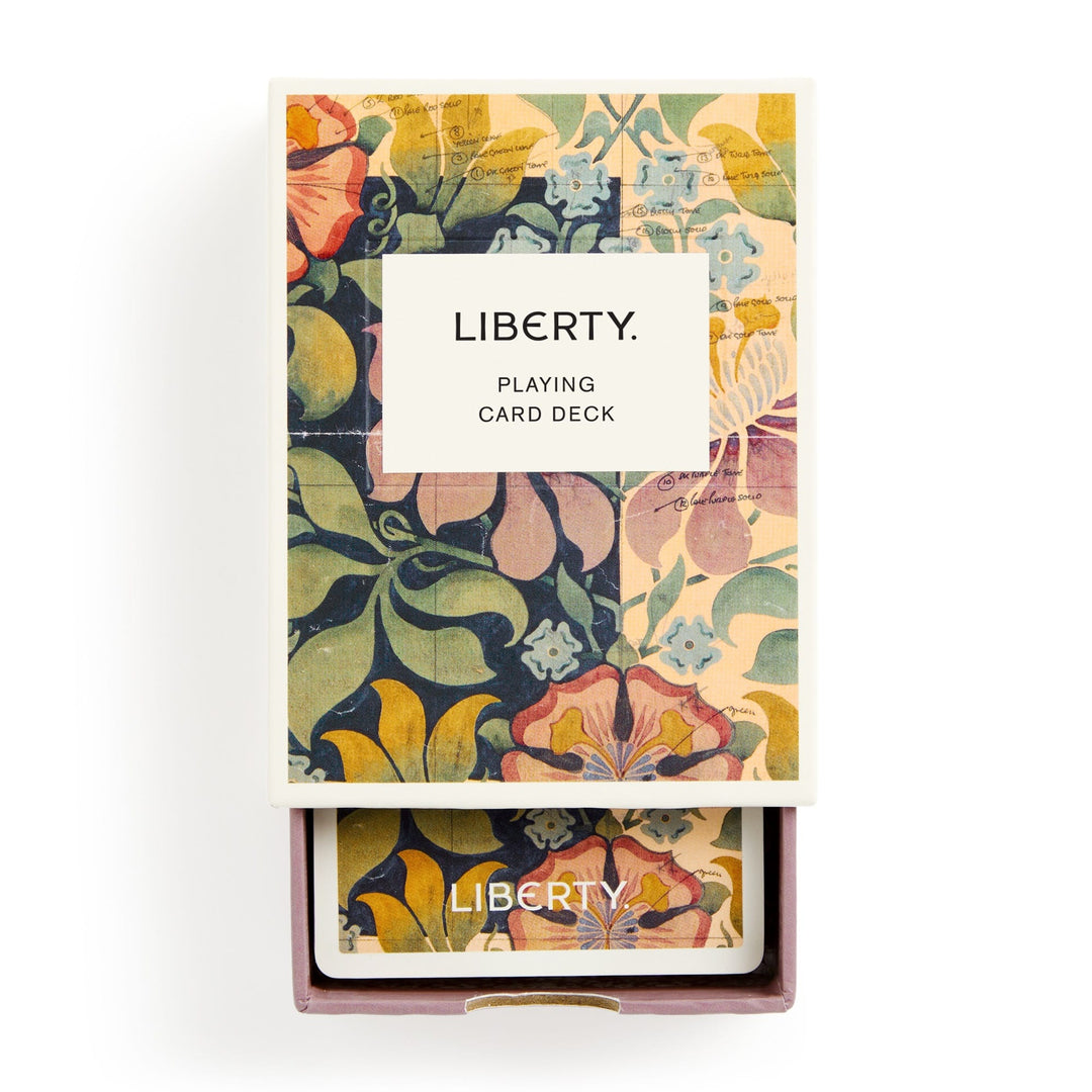 The Liberty Archive Playing Card Deck by Liberty London features vibrant floral patterns inspired by textile heritage on the packaging and card backs, with a white label on the front reading LIBERTY. PLAYING CARD DECK.