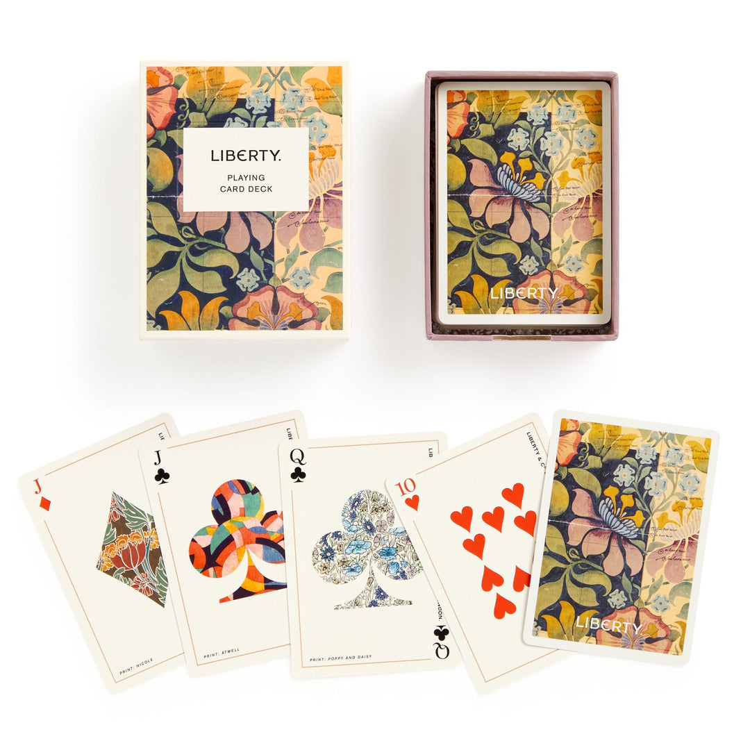 The Liberty London Liberty Archive Playing Card Deck features a vibrant floral design inspired by textile heritage. Displayed are the Jack of Diamonds, Jack of Clubs, Queen of Clubs, Ten of Hearts, and the colorful floral card back.
