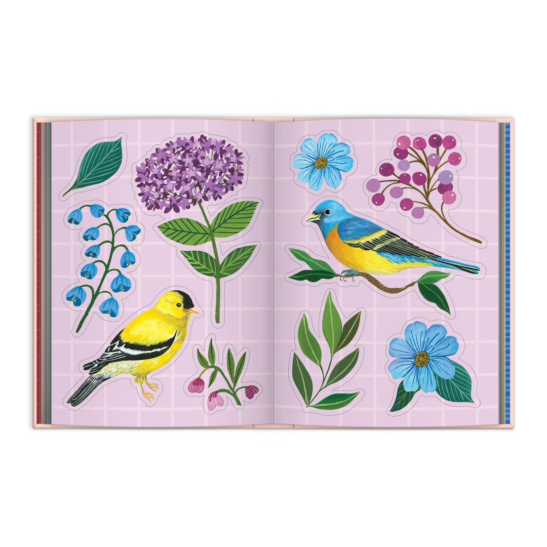 The Christine De Carvalho Art of the Forest 100 Page Sticker Book features an open spread with vibrant birds, purple and blue flowers, berries, and green leaves on a pink grid background, capturing whimsical forest scenes.