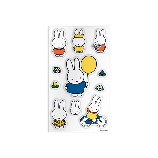 The Miffy Sticker Tin by Miffy features stickers of Miffy the bunny in outfits and poses—holding a yellow balloon, carrying flowers, riding a bike—plus small flower and bunny stickers, all on a white background.