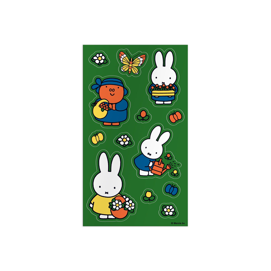 The Miffy Sticker Tin by Miffy features colorful stickers of cartoon rabbits in blue and yellow dresses, a rabbit watering flowers in a red pot, plus butterflies and bees all on a green background.
