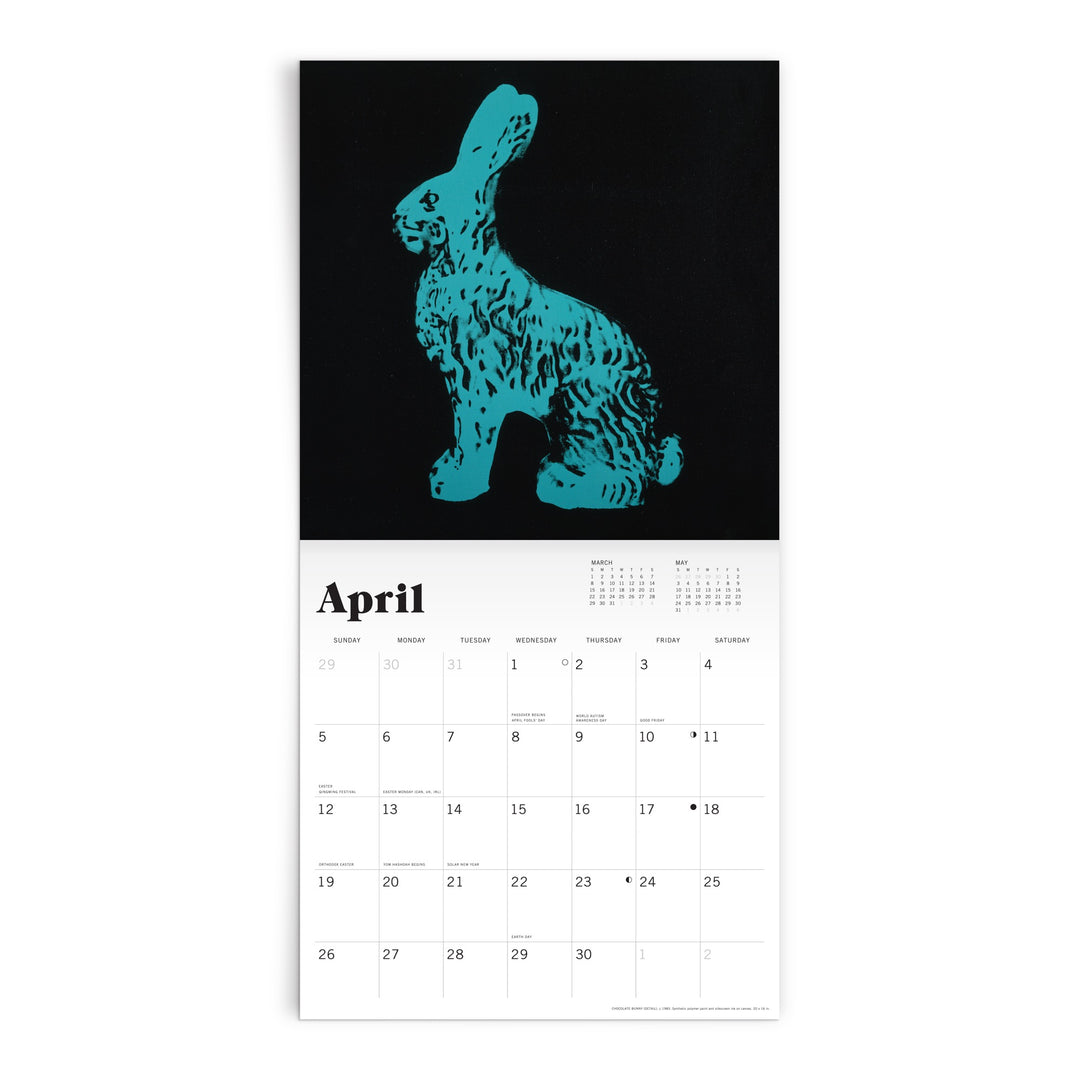 The Andy Warhol 2026 Classic 12 x 12 Wall Calendar by Andy Warhol displays a pop art-style blue-green rabbit on black for April, with the dates and days shown in black text on a white background below.