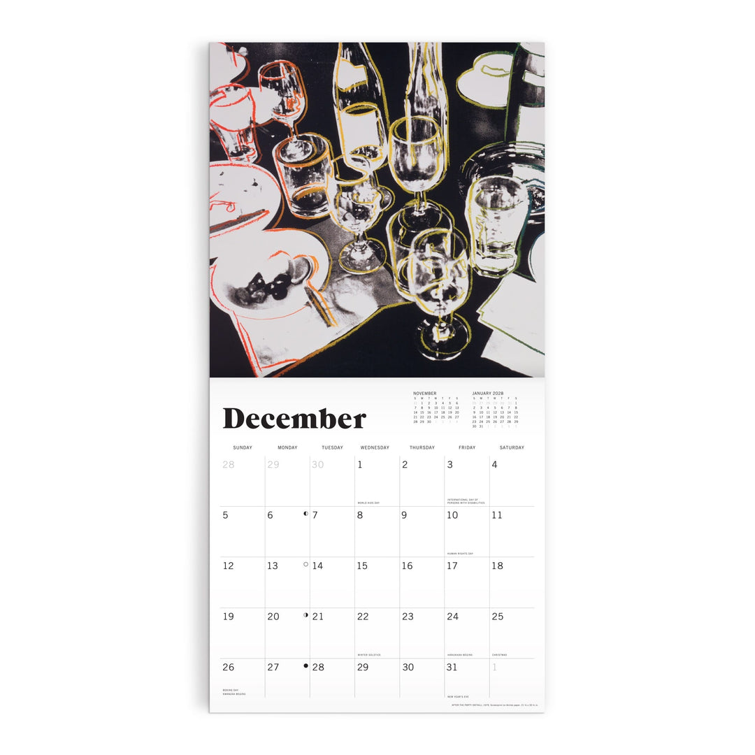 The Andy Warhol Foundation For The Visual Arts 12 x 12 Wall Calendar 2027 features December’s page with artwork of a dinner table set with glasses, bottles, plates, utensils, the month’s days below, and a yearly overview at the top.