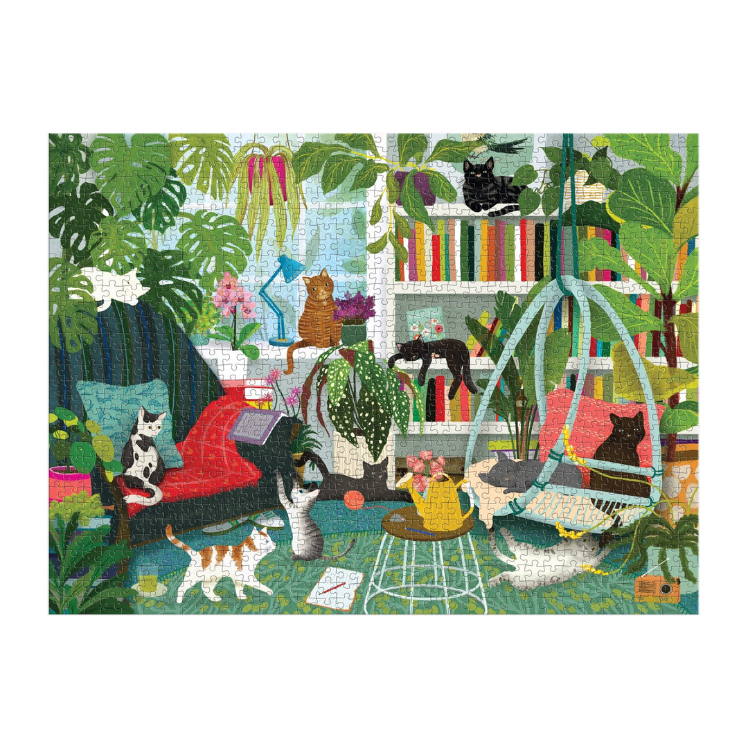 The Good Puzzle Co. Cat Haven 1000 Piece Puzzle by Katherine Quinn features illustrated cats lounging among plants, bookshelves, and cozy furniture in a colorful room—crafted from recycled materials.