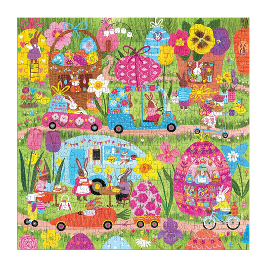 The Hoppin' Around 500 Piece Family Puzzle by Jenny Miriam features whimsical bunnies in egg-shaped houses, driving cars and bikes among giant flowers and eggs—a colorful family puzzle ideal for all ages.