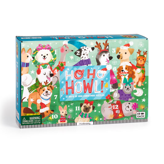 The Kathryn Selbert Ho Ho Howl! Countdown Puzzle Set features a colorful box with cartoon dogs in Christmas outfits around a green “HO HO HOWL!” sign, perfect for mini puzzle family fun or as a holiday dog puzzles gift.